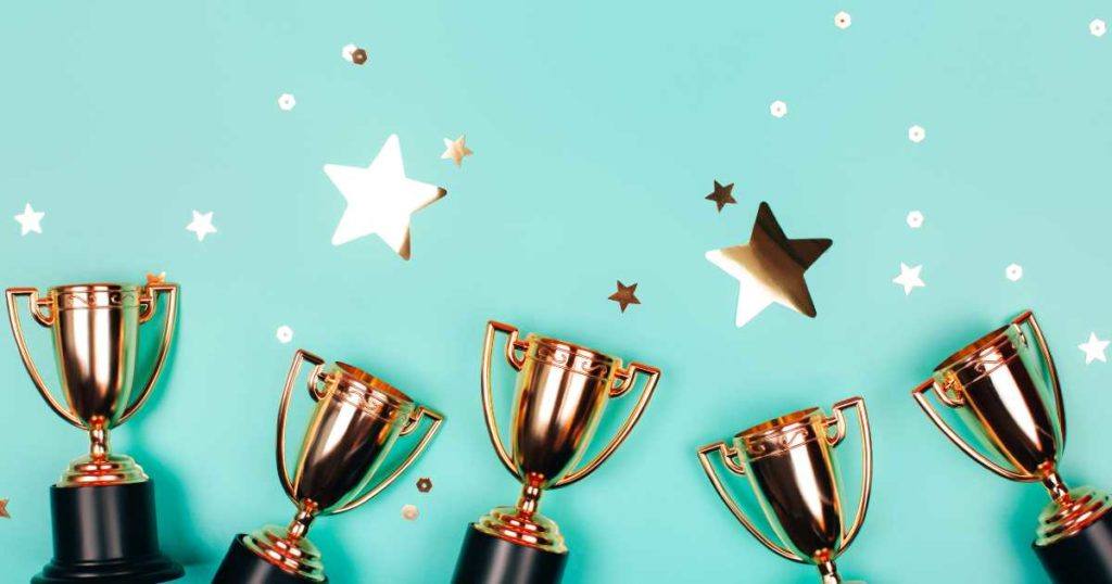 trophies and stars on a light blue background