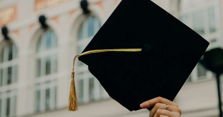 graduation cap held in the air