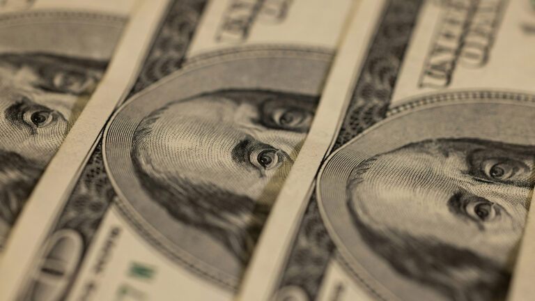 Close-up of overlapping hundred dollar bills