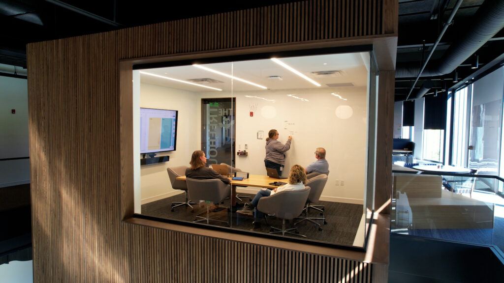 SEP team collaborating at a whiteboard in a conference room