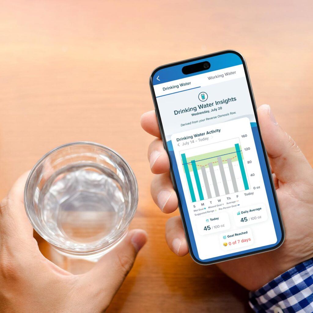 man holding a glass of water and looking at water insights on his phone app