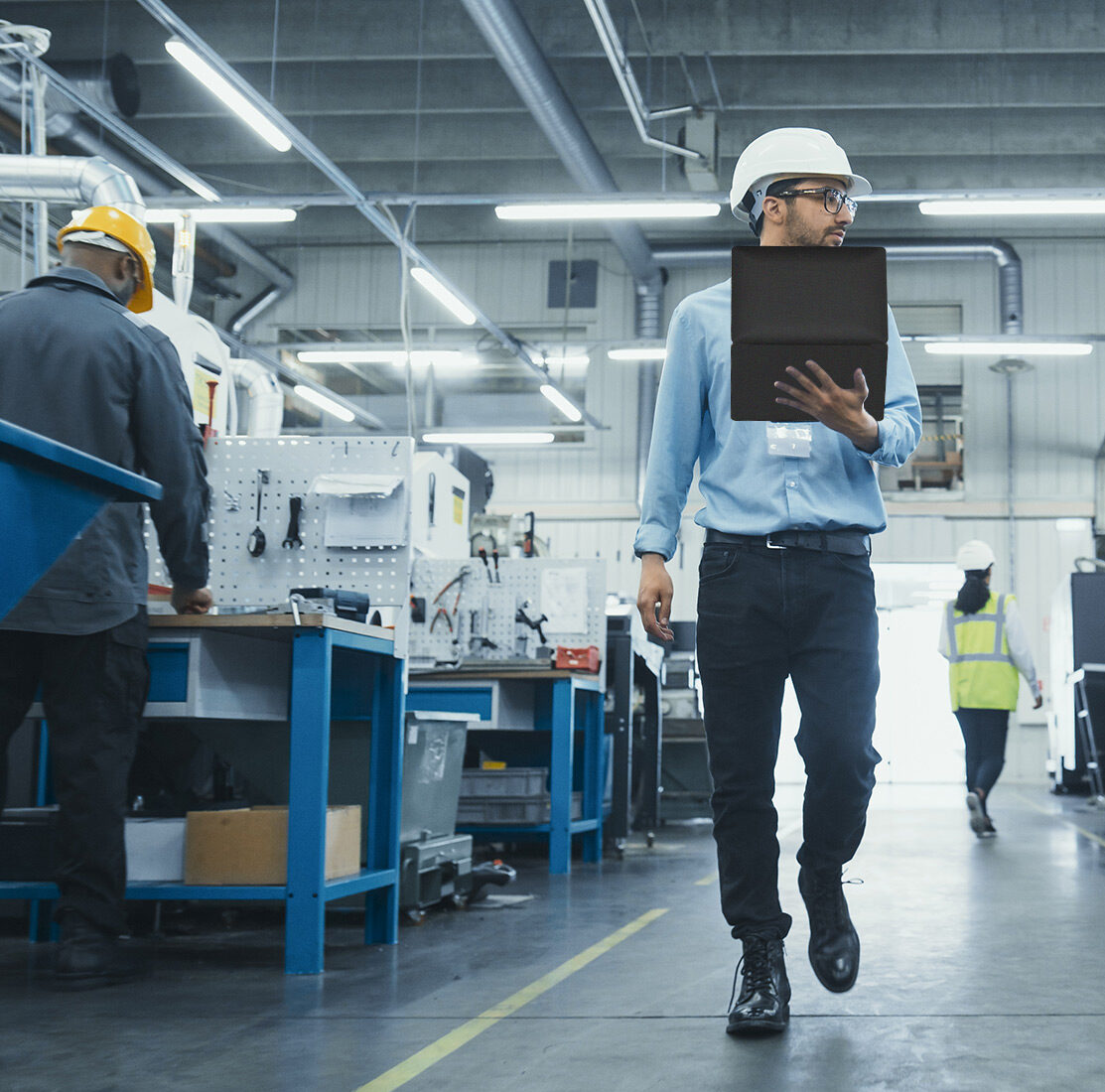 foreman holding laptop in plant