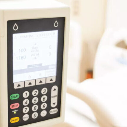 infusion pump in front of patient hospital bed