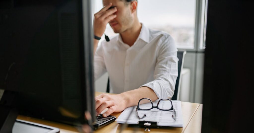 exhausted software developer at desk