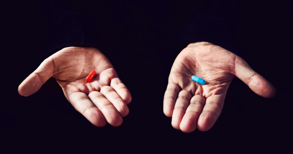 red pill blue pill hands holding them out
