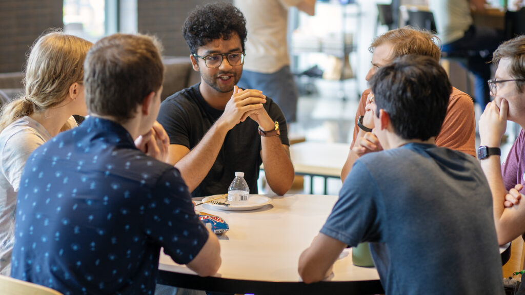 Group of SEP team members discussing around a round table